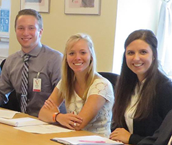 Several students pictured at a table at a U.S. Embassy meeting