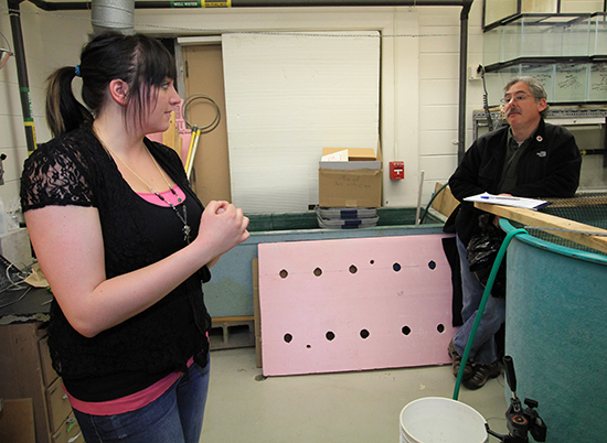 Krista Hines and Roger Haro in the lab talking.
