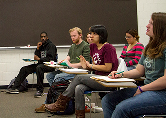 UW-L students sitting at their desks taking notes and listening to a lecture. 