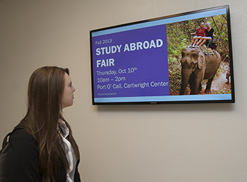 A student views a new digital sign installed in Graff Main Hall. 