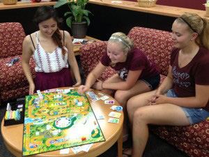 Students playing board game.