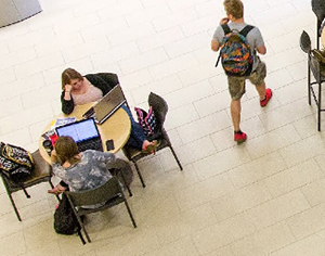 Image from the top looking down at students studying at a table in Centennial Hall. 