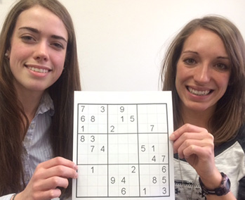 UW-L seniors from left, Chloe Peebles and Jenna Halvorson, hold a Sudoku puzzle.