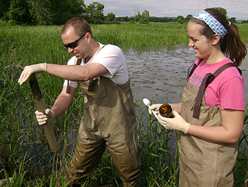 Two students doing tests in marsh.