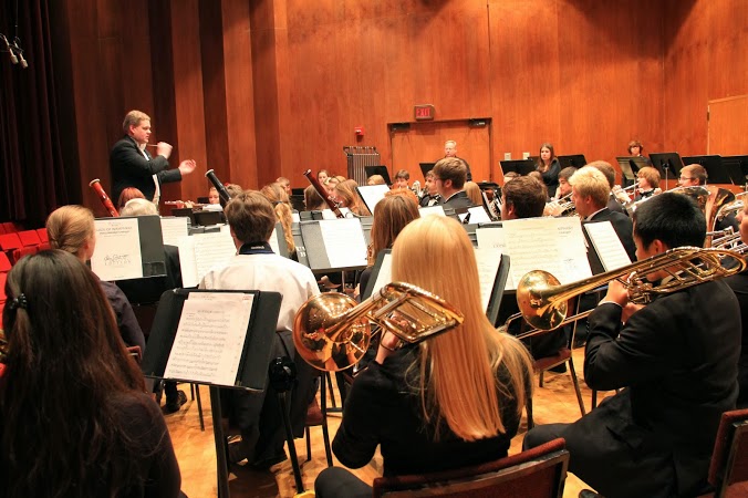 Image of the band playing in a recital hall. 
