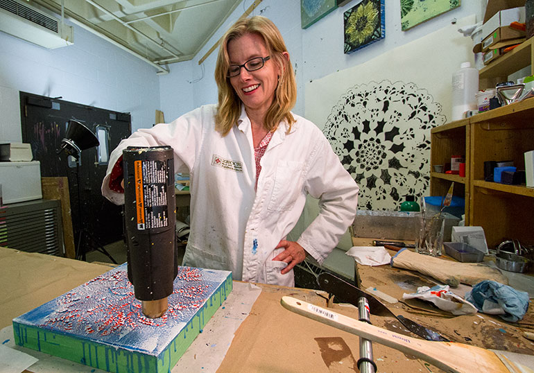 Jennifer working in her art studio.