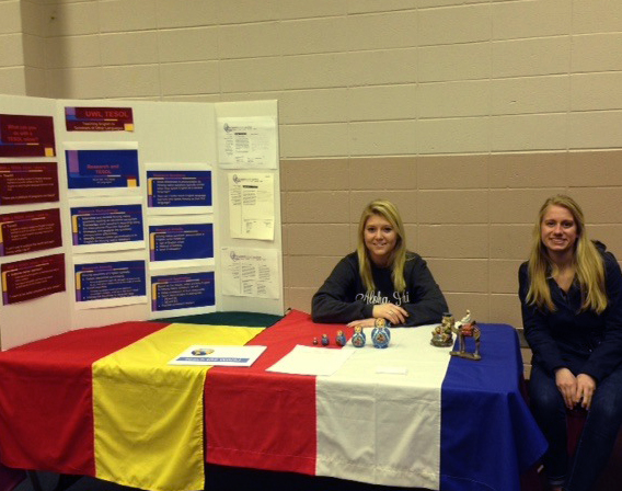 Image of two students sitting at a booth.