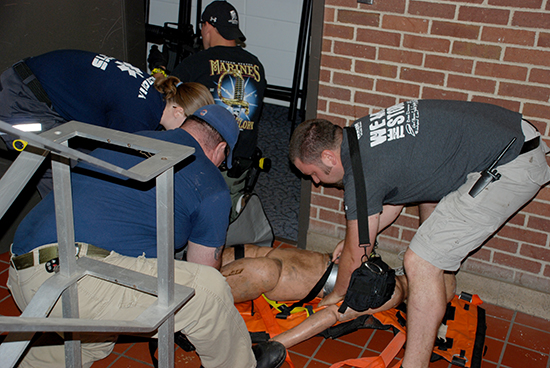 Officers moving a manaquin.