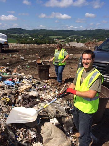 Dan Liska, UW-L graduate student in microbiology, collecting samples at the La Crosse County Landfill for his research. He is pictured with Bonnie Bratina, UW-L microbiology professor.
