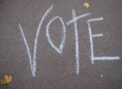 vote Word vote chalked on sidewalk.