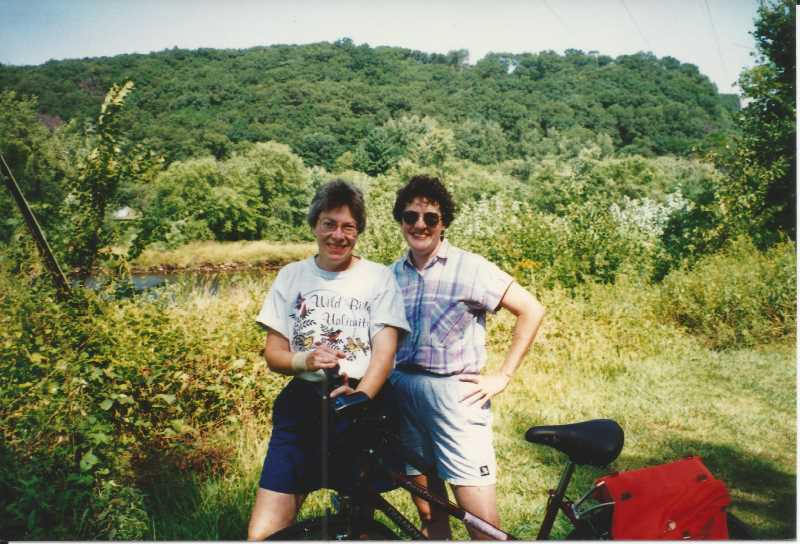 Alums Kristine Mason (left) and her partner, Jane Schley, during a bike ride in the 1990s. After Mason died in 2001 at age 50, Schley established a scholarship fund in her honor, supporting School of Education students with a financial need.