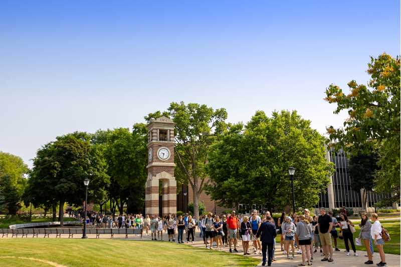 Students and adults walking past Hoeschler Tower on a June 2023 START day. 