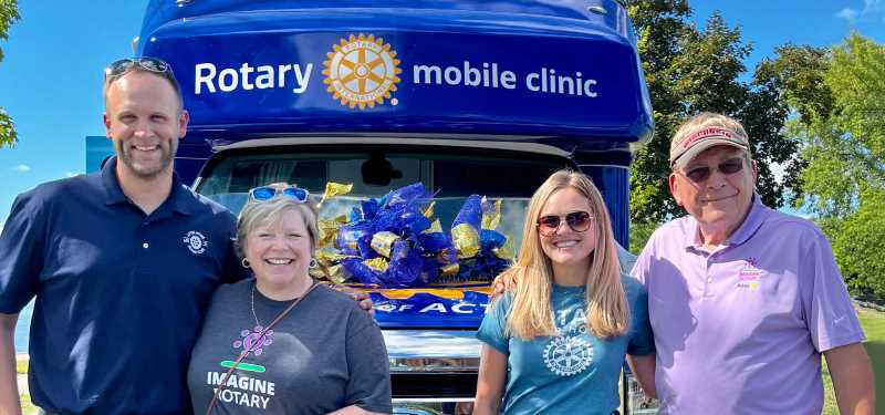 From left to right: Rotarians Josh Mansee, '10; Janie Morgan, ’85 & ’86; Marissa Dickinson; and Dean Dickinson, ’68; show off St. Clare Health Mission's new Rotary Mobile Clinic. UWL alumni were critical in securing funding for the project.
