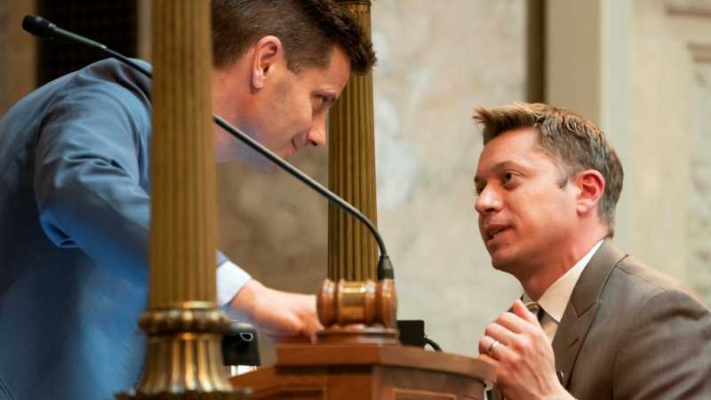 Mike Queensland, '07, right, discusses a procedural matter with Wisconsin Senate President Chris Kapenga. Queensland is the Senate's parliamentarian and chief operating officer, a position he has held since 2021. PHOTO CREDIT: Greg Anderson, '83, staff photographer, Wisconsin State Legislature 