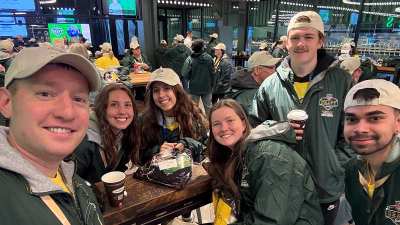 Sam Schmidt (left), assistant professor of Exercise & Sport Science, accompanied students to the NFL Draft in Green Bay, where they gained valuable experience volunteering at the NFL's signature offseason event.