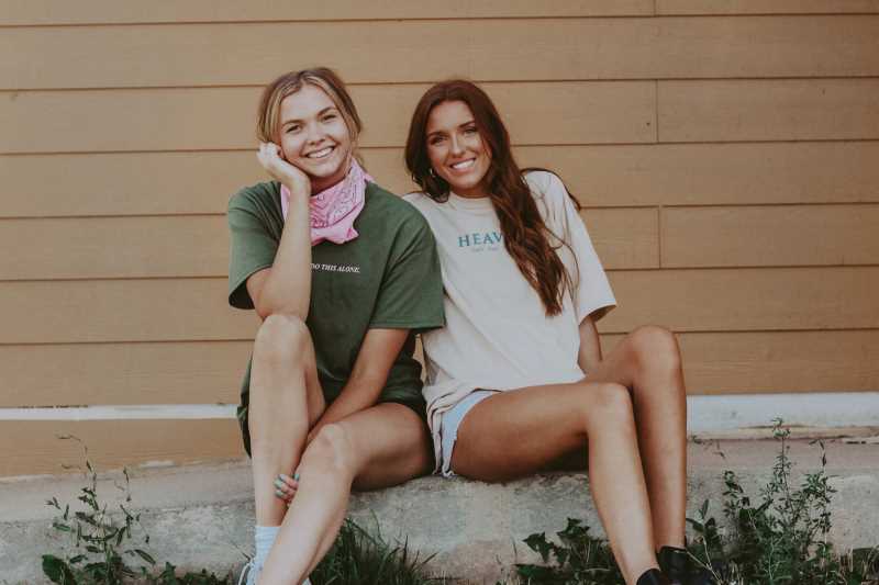 UW-La Crosse marketing major Olivia Steingraber, left, and her business partner, UW-Madison student Megan Kronseer, wear T-shirts from their business.