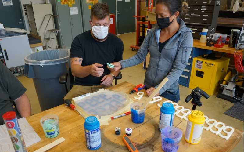 Zach Heinkel, '18, a composite materials engineer with the Carderock Division of the Naval Surface Warfare Center in Bethesda, Maryland, is part of a four-person team using 3D printers to produce masks, visors and hands-free door openers for employees at various naval facilities.