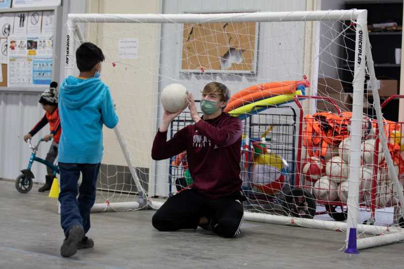 The UW-La Crosse Men’s Track and Field team, along with physical education faculty, hosted six sport camps to keep young children active during the first week of January. Photo by U.S. Army. Photo by Spc. Caitlin Wilkins, 50th Public Affairs Detachment.