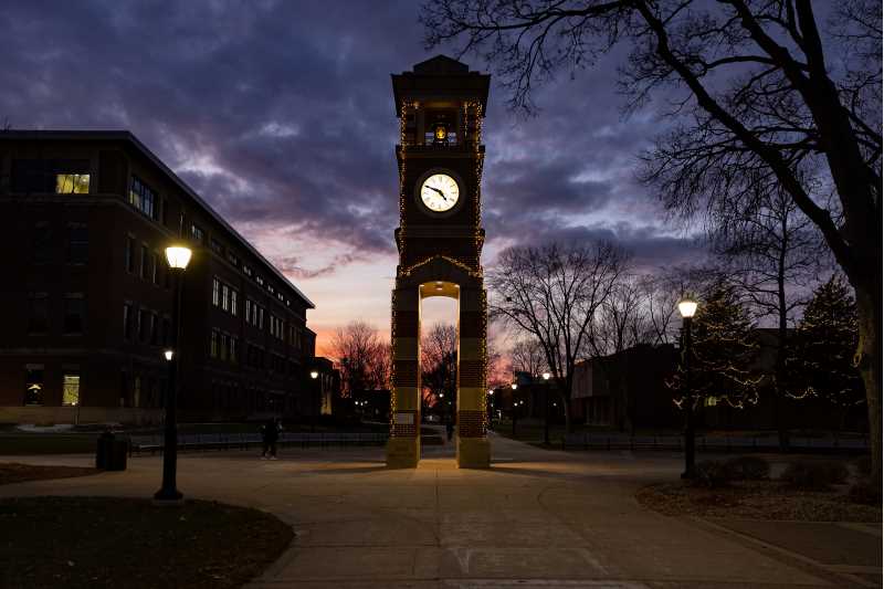A purple and orange sky illuminate the UWL Hoeschler Clock Tower at sunset in early December