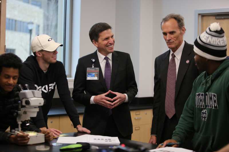UWL Chancellor Joe Gow, second from right, and Paul Mueller, regional vice president for Mayo Clinic Health System, third from right, talk with UWL students in a Prairie Springs Science Center Lab following the research agreement announcement in November 2019. The two organizations have released the first projects in the Collaborative Seed Grant Program.