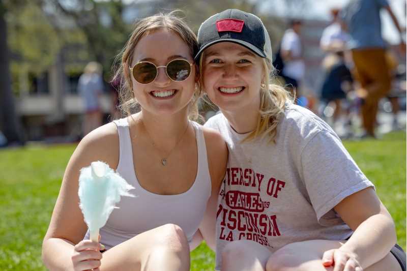 Students sit together on the campus lawn. Meeting new friends and spending time with others around campus and in the community are just a couple of ways alumni have felt at home on campus.