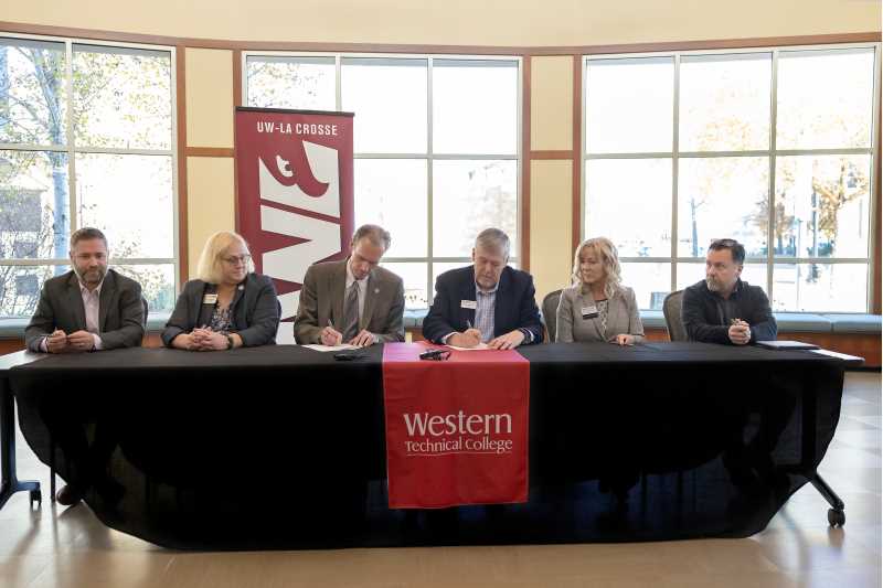 UWL Chancellor Joe Gow, left center, and Western President Roger Stanford, right center, signed official articulation agreements on Nov. 1, 2022.