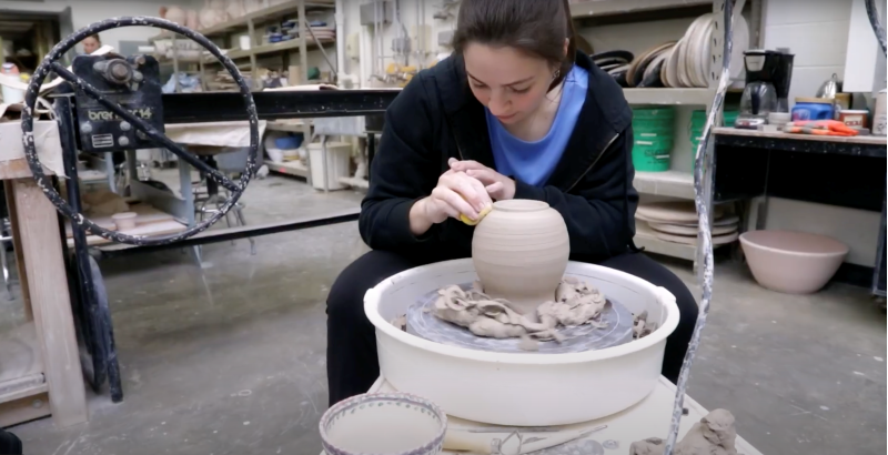 A student makes pottery at the School of Visual & Performing Arts.