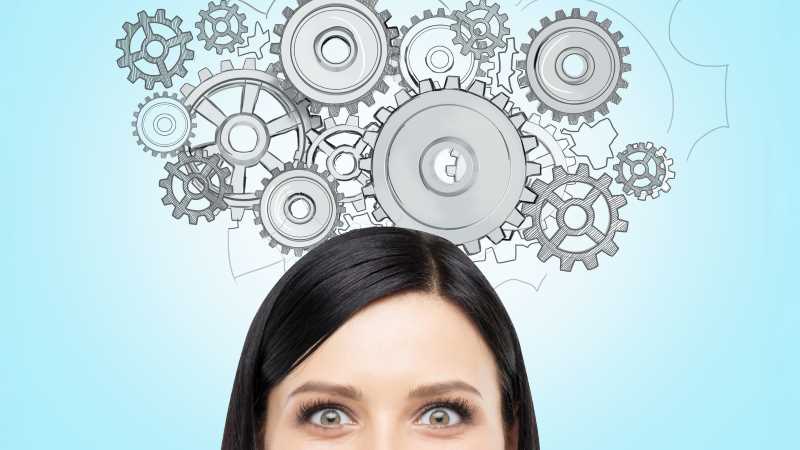 Gears turning above a woman's head.