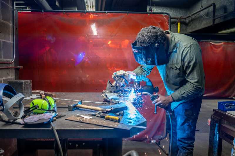 Sculptor Wilay Méndez Páez at work welding a sculpture during a workshop on campus. He brought a week of creative energy to UW-La Crosse this spring as a visiting artist.