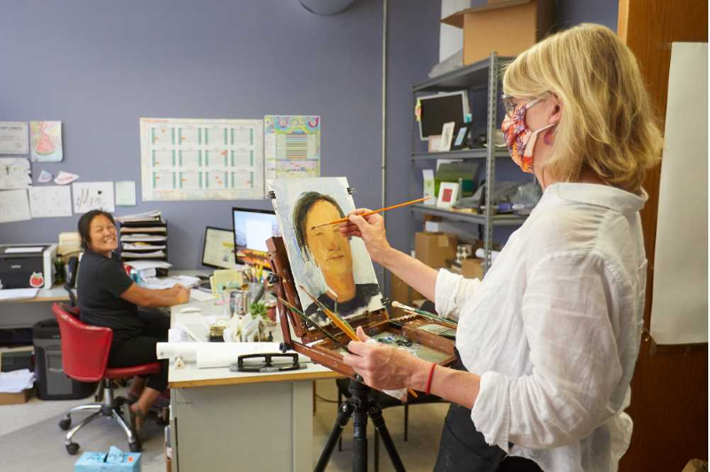 UWL Art Professor Jennifer Williams paints a portrait of Tami Plourde