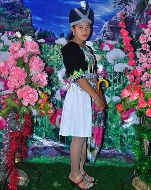 Photograph of young woman in front of large flower display