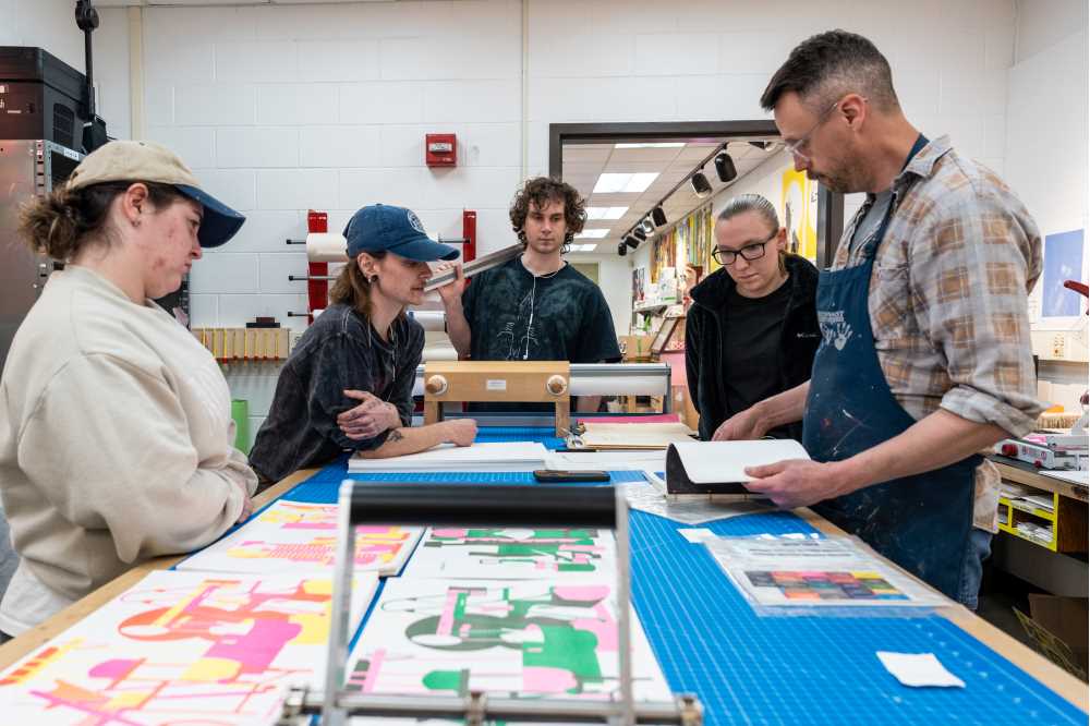 Travis Head doing printmaking with UWL students