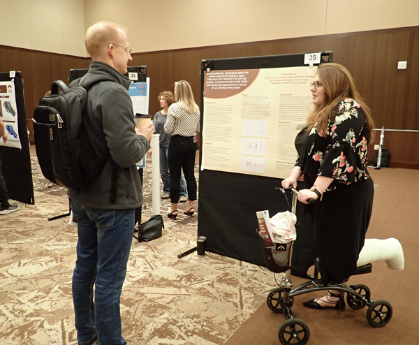 Ashley Nowak presenting research to Tim McAndrews