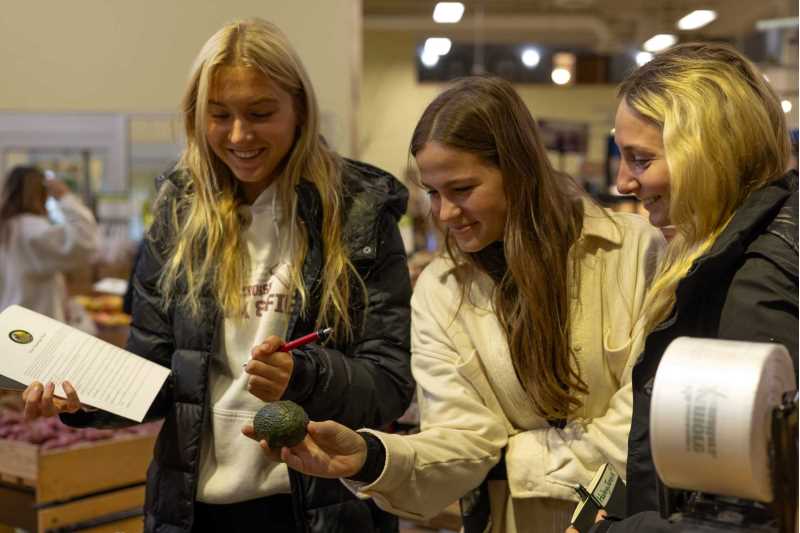 Students looking at an avocado