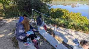 Students painting by the marsh