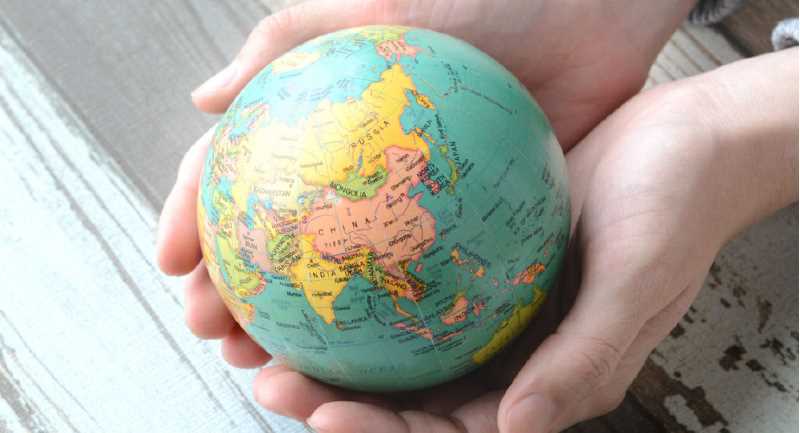 Hands holding a globe