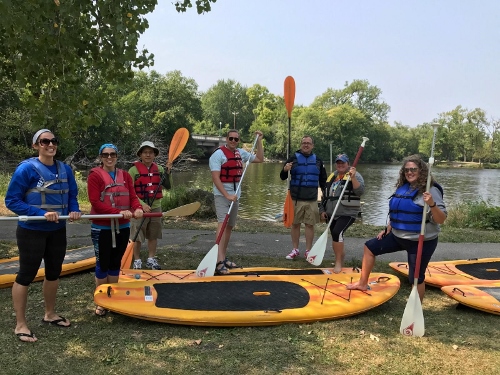 RMTR Faculty on paddle boards at summer retreat