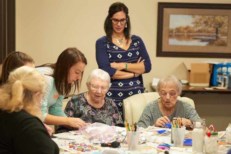 Lindsey Kirschbaum, an associate lecturer in the Recreation Management and Therapeutic Recreation Department, oversees students in her therapeutic recreation class working with residents in a La Crosse manor.