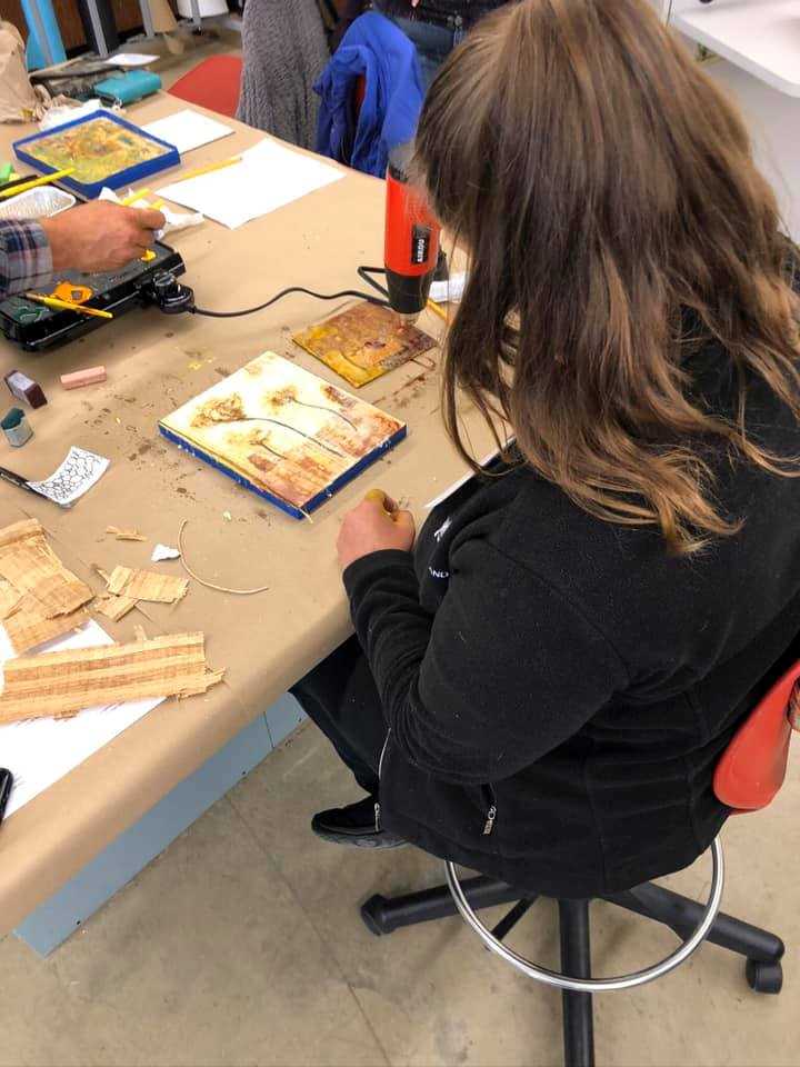A student creates a floral painting