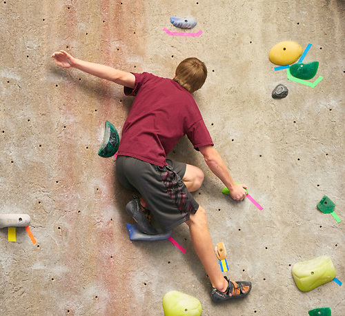 Individual on climbing wall.