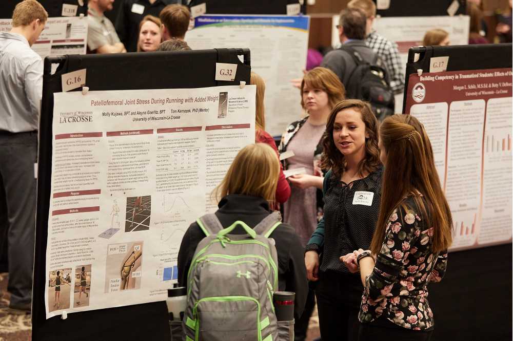 Student presenting with research poster