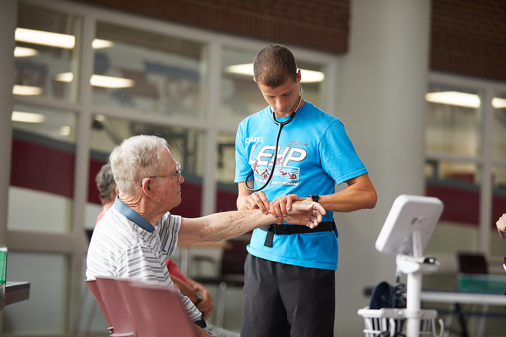 Student works with LEHP participant