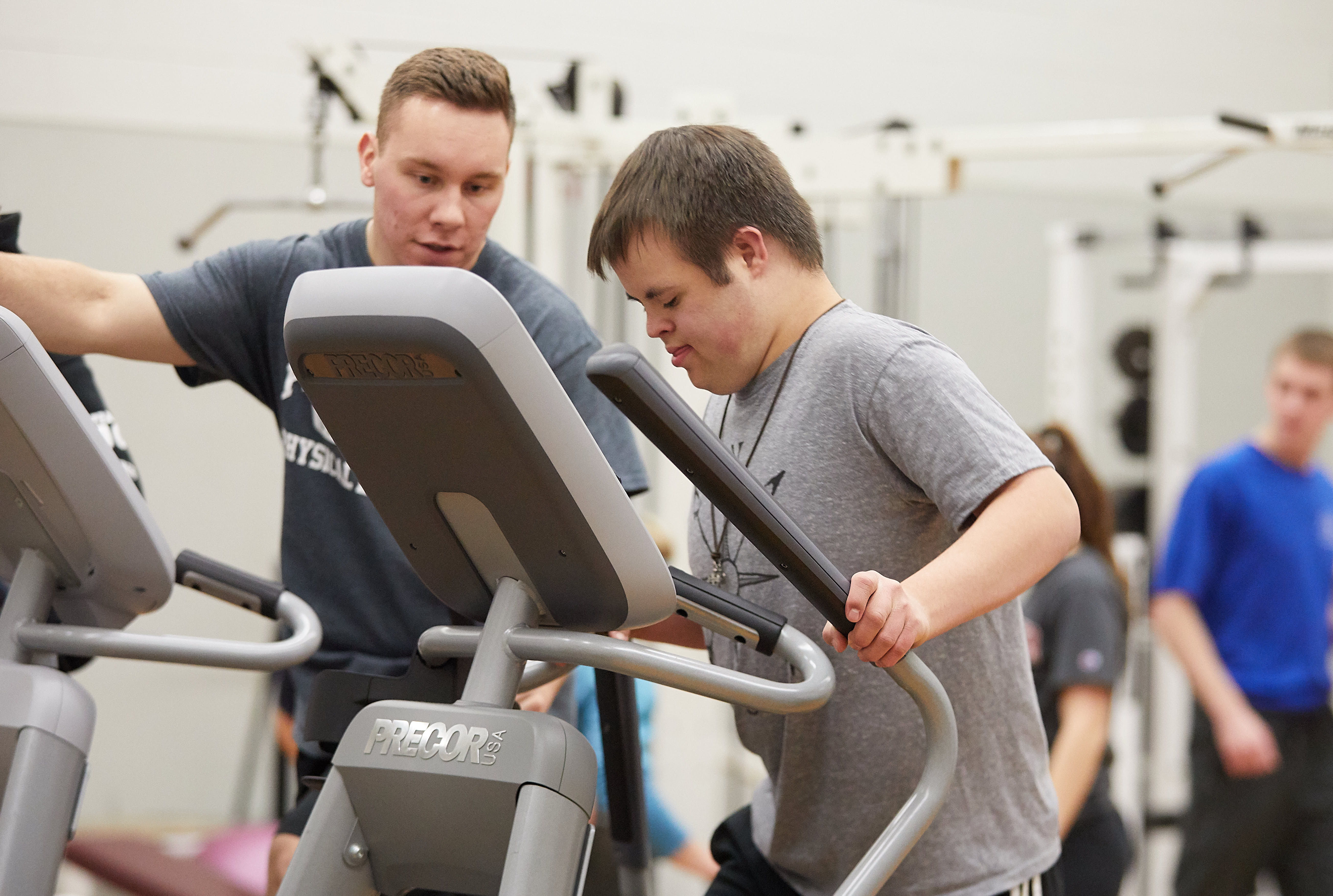 Students helping youth on bike