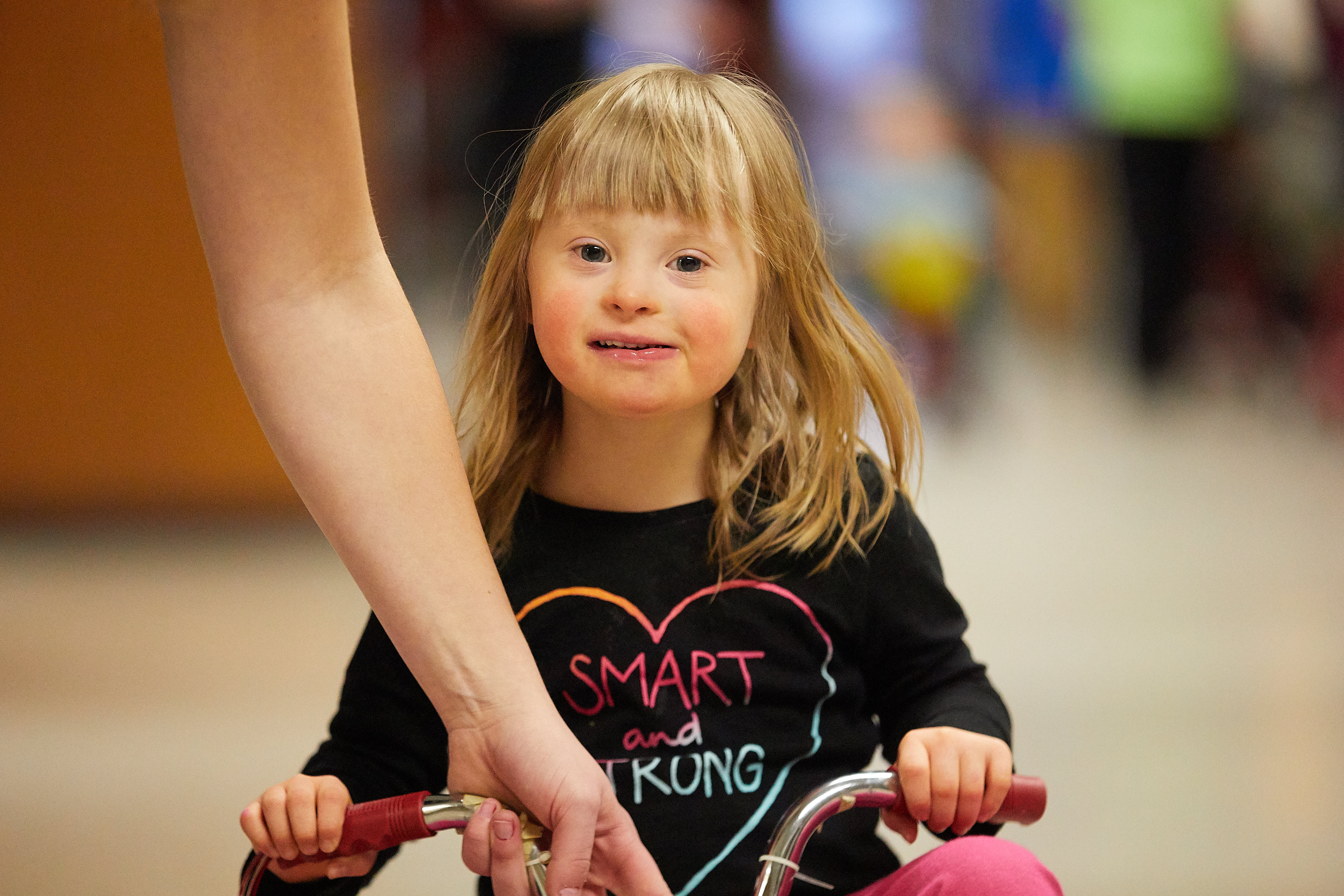 Child biking with student