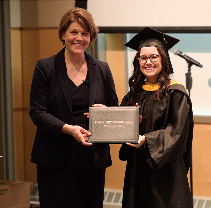 Program director and student at PA hooding ceremony