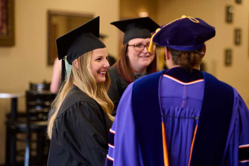 Students visit at the Hooding Ceremony