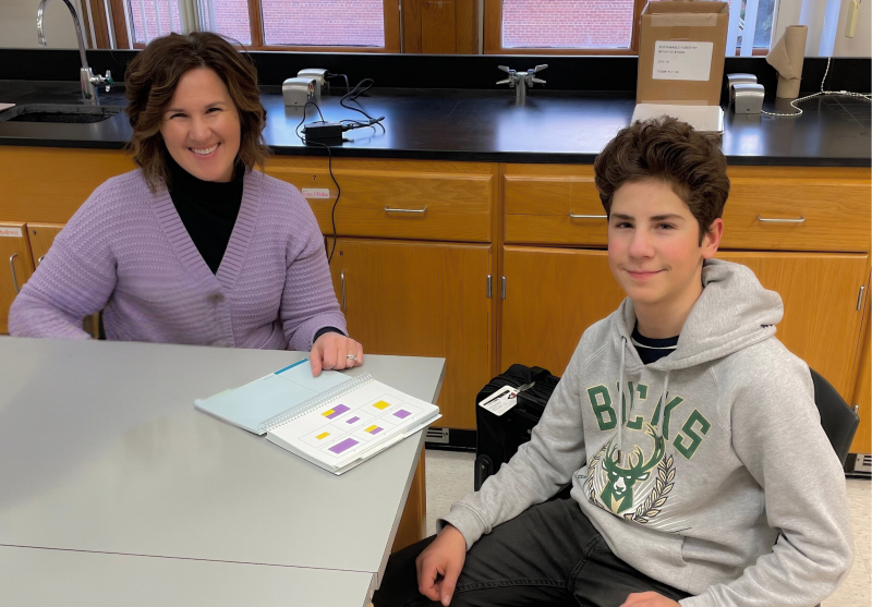 School Psychologist meets with a student in a classroom setting.