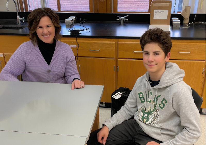 School Psychologist meets with a student in a classroom setting.