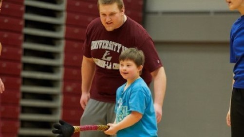 A child plays in the fieldhouse during the Motor Development program.