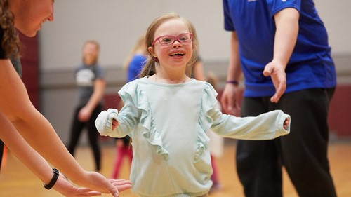 Girl runs in the Fieldhouse during the Motor Development Program.